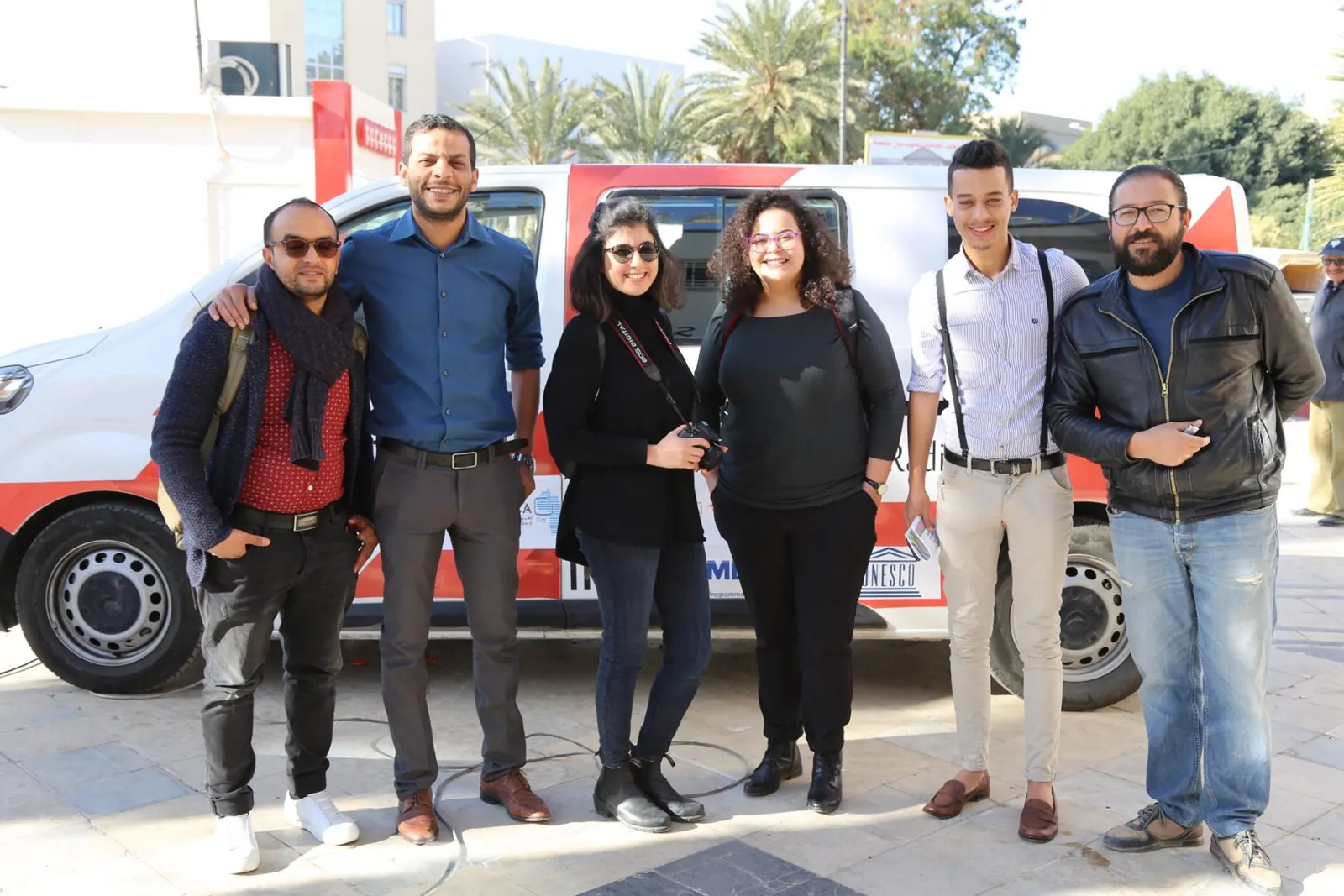 The Radio Capsa FM team in front of the station's vehicle in central Gafsa